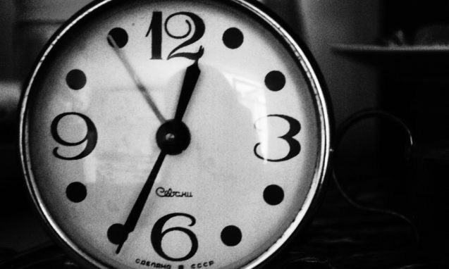 A black and white image of an old clock