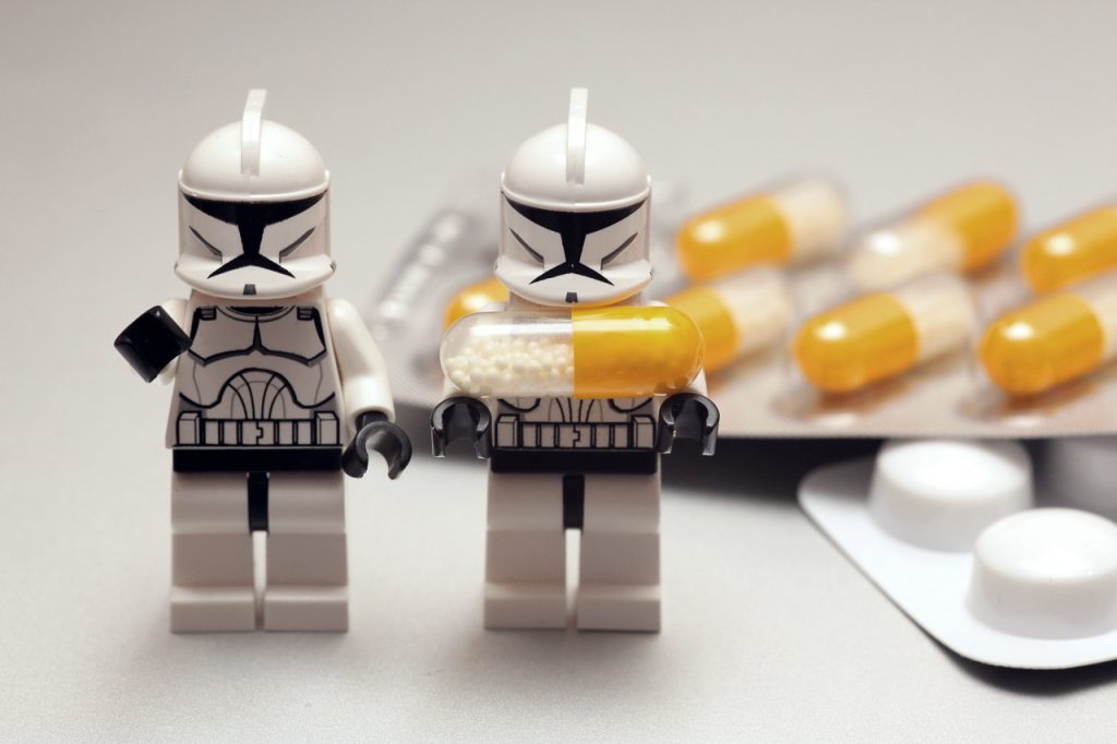 A lego clone trooper holding a medicine capsule