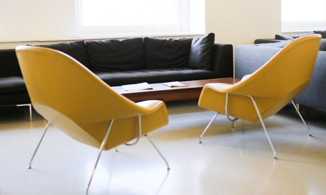 two yellow chairs in a sunny office space