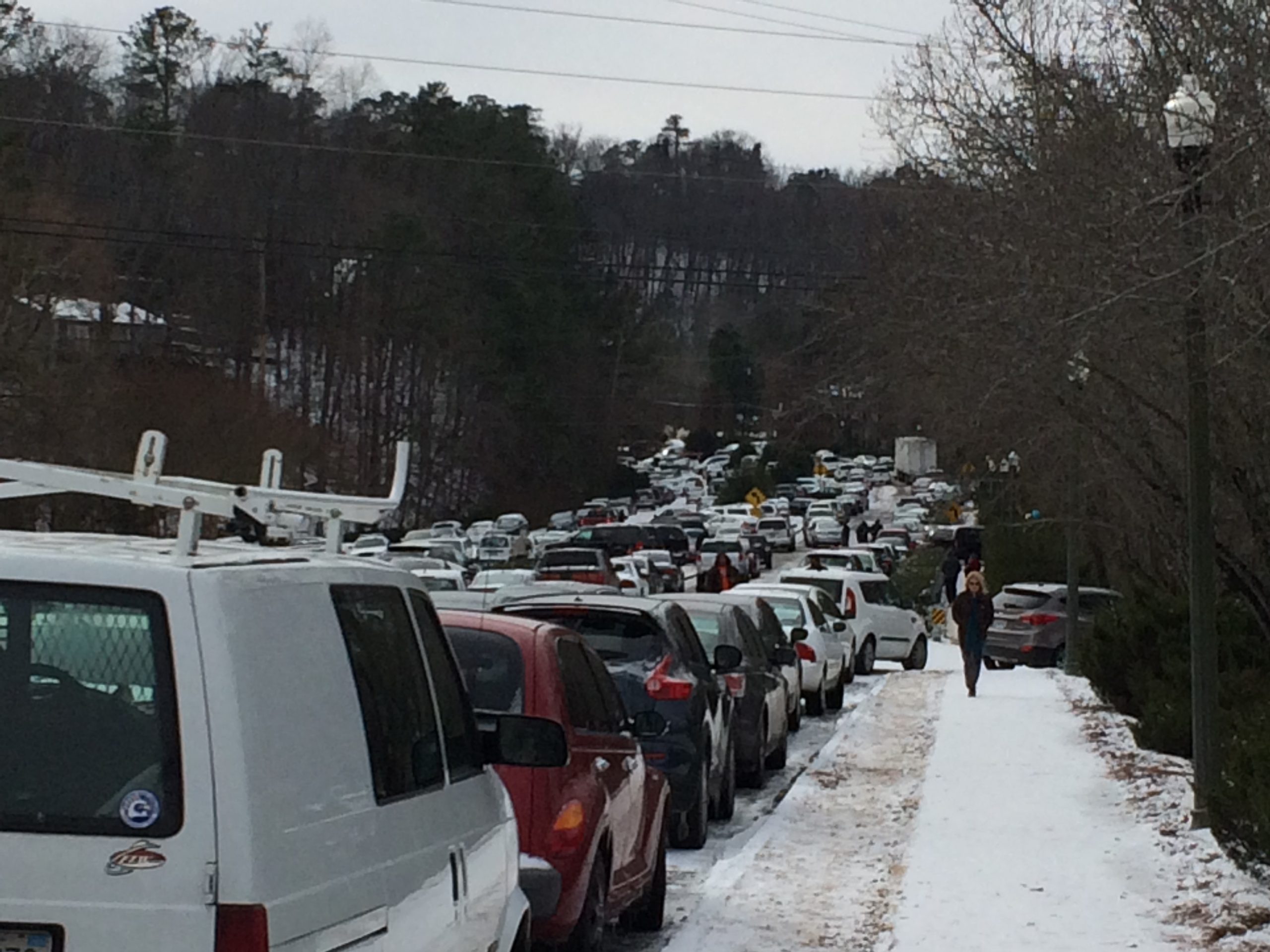 Multiple cars backed up on a snowy day