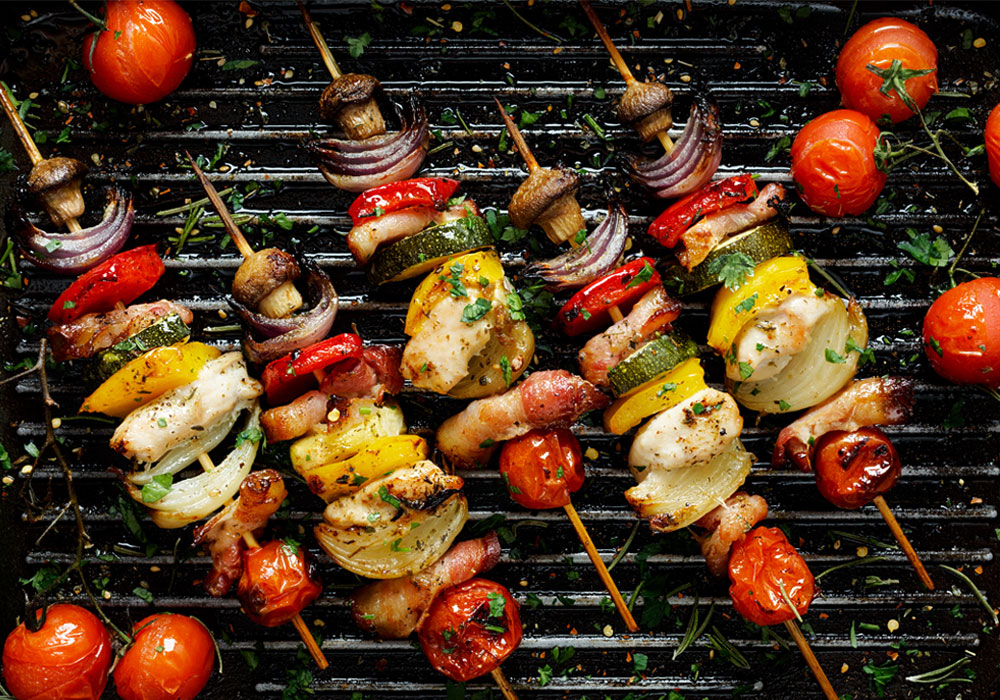 herb-seasoned grill with grilledcherry tomatoes and kabobs with mushrooms, onions, bell peppers and zucchini