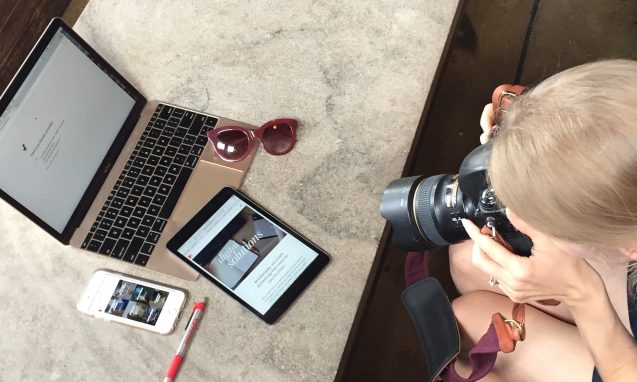 woman photographer takes photo of a laptop, sunglasses, ipad, iphone, and Infomedia pen