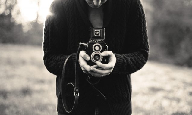 A man holding an old camera
