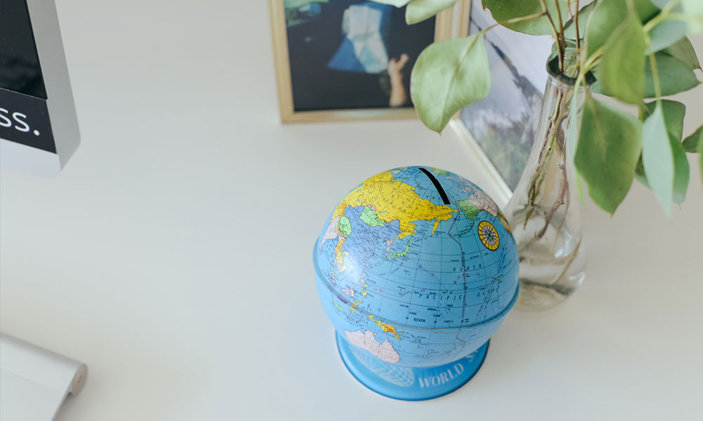 a tin globe on a white desk in a beautiful office
