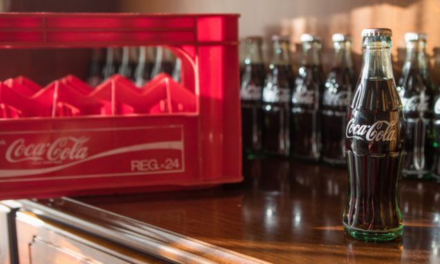 glass coca cola bottles on a countertop