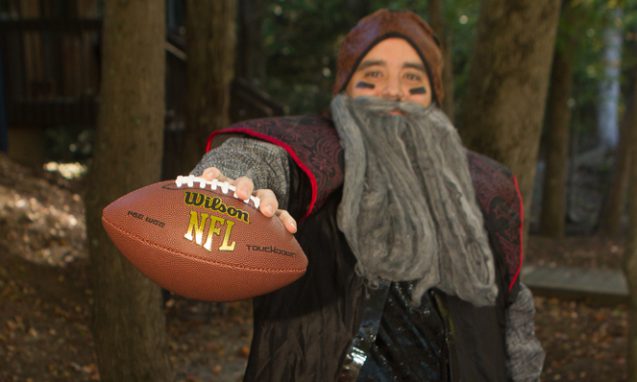 man dressed as a fantasy character holding a football for infomedia's Halloween costume contest