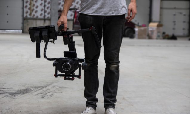 man holding a large videography camera