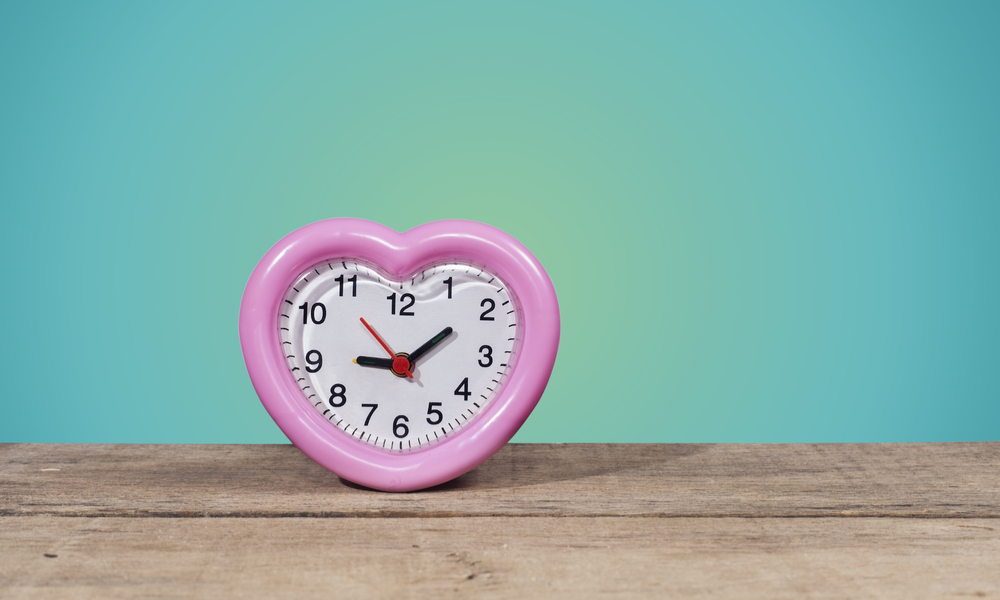 heart shaped clock on a wooden table