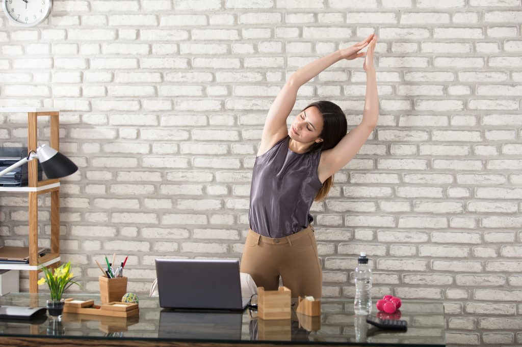Woman taking a break from working and stretching