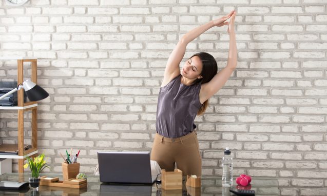 Woman taking a break from working and stretching