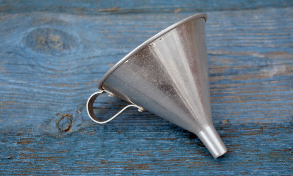 metal funnel on a wooden background