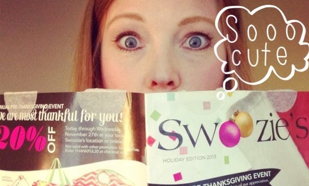 A woman holding a "swoozie's" magazine