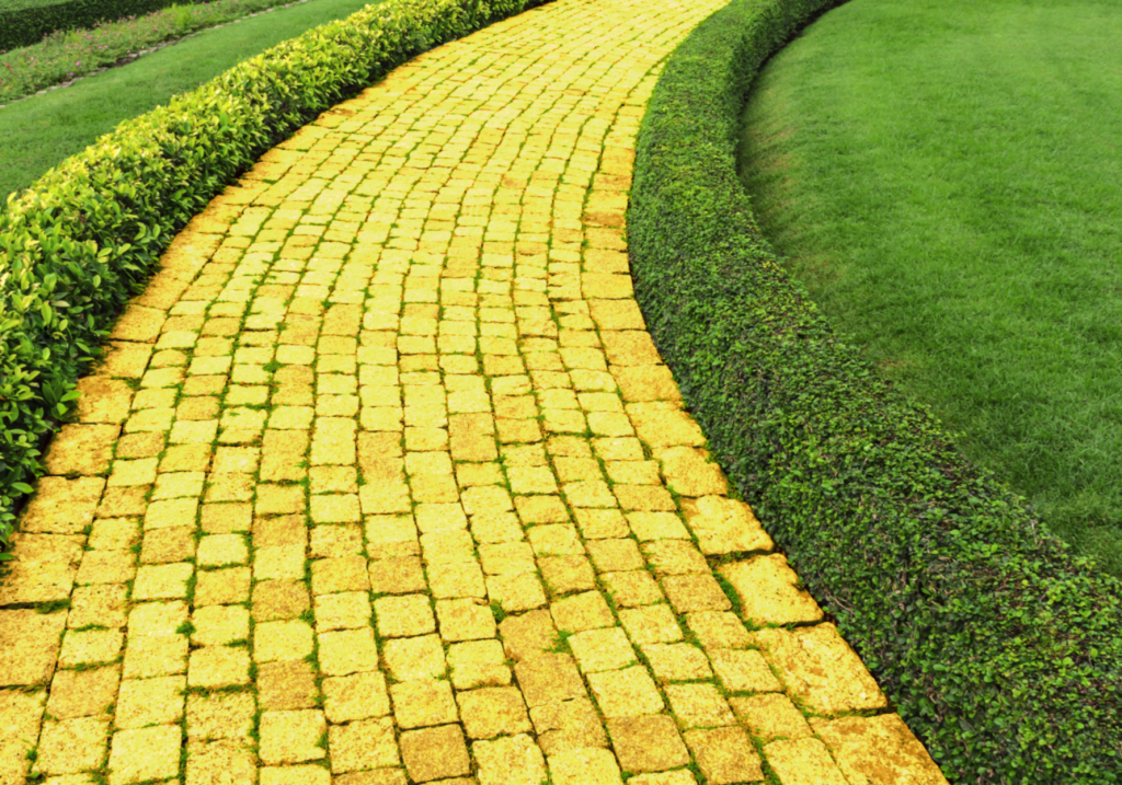 A yellow brick road winds through a green field
